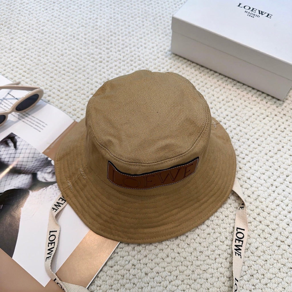 Soft canvas bucket hat with embossed leather logo patch and adjustable chin strap