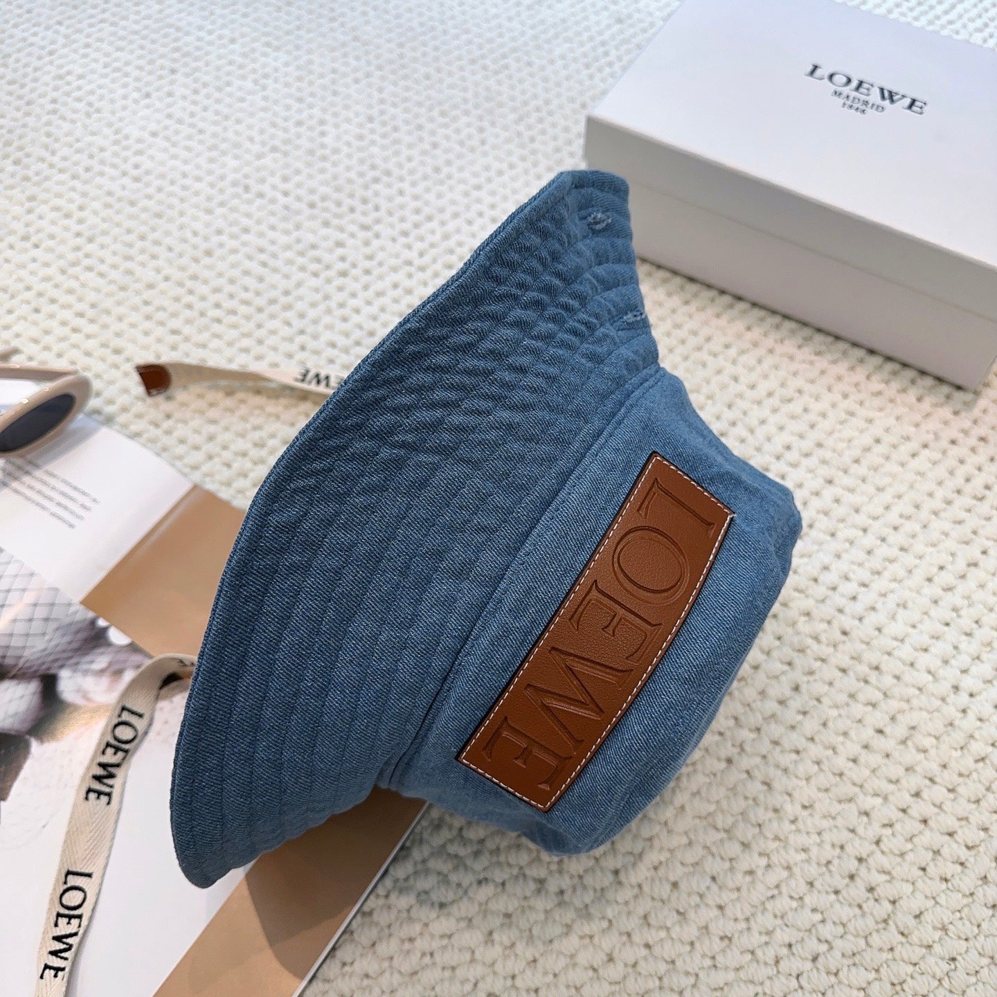 Denim bucket hat with embossed patch and detachable strap