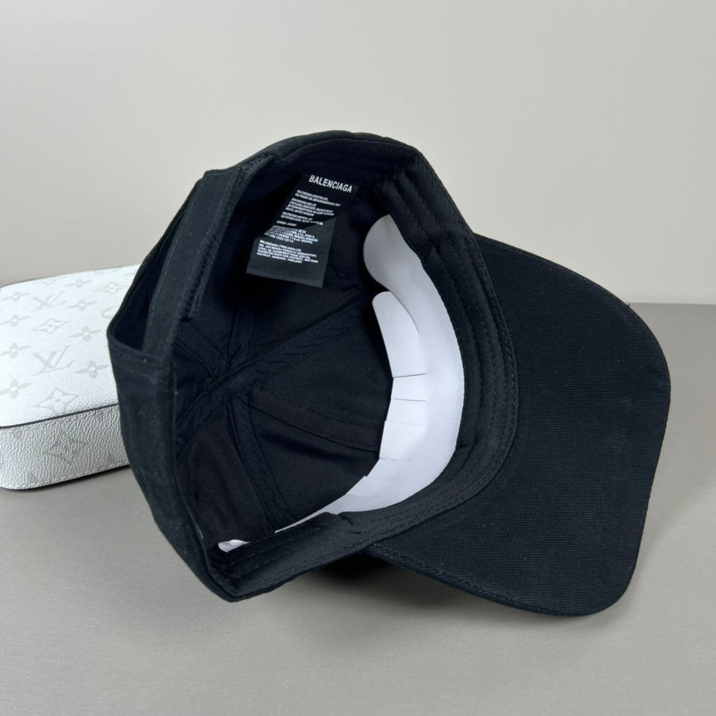 Black cotton cap with white oval emblem embroidery