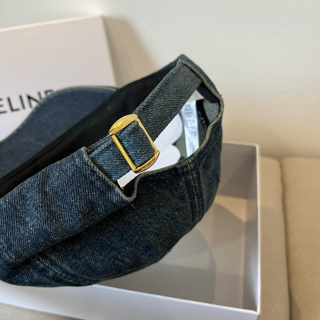 Washed blue denim cap with tonal emblem and gold buckle